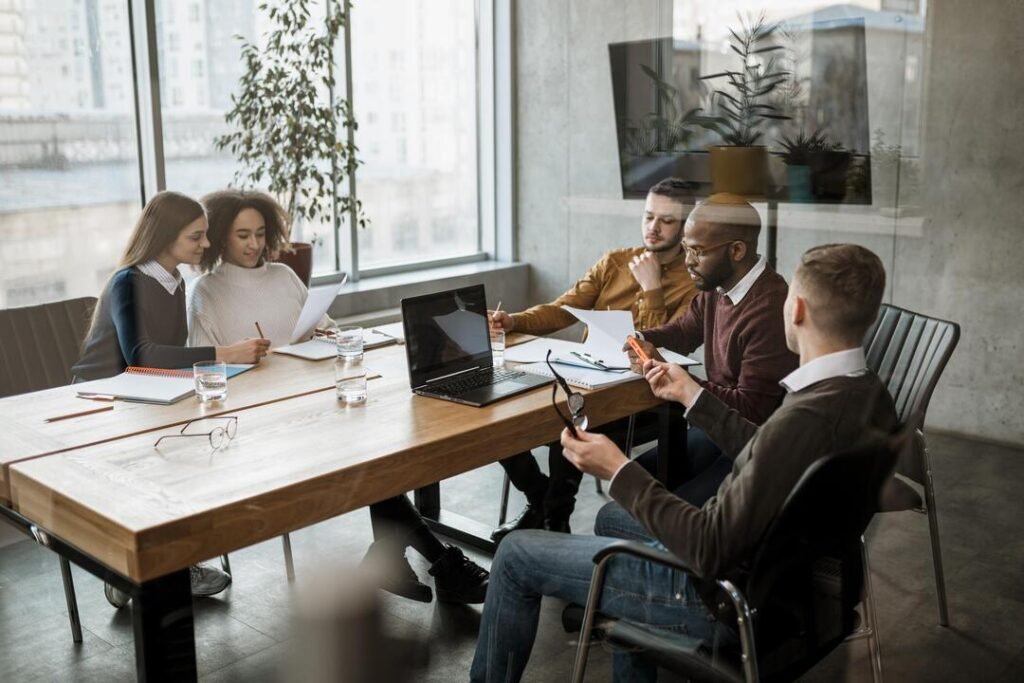 Grupo de pessoas realizando uma reunião no escritório e conversando sobre backoffice.