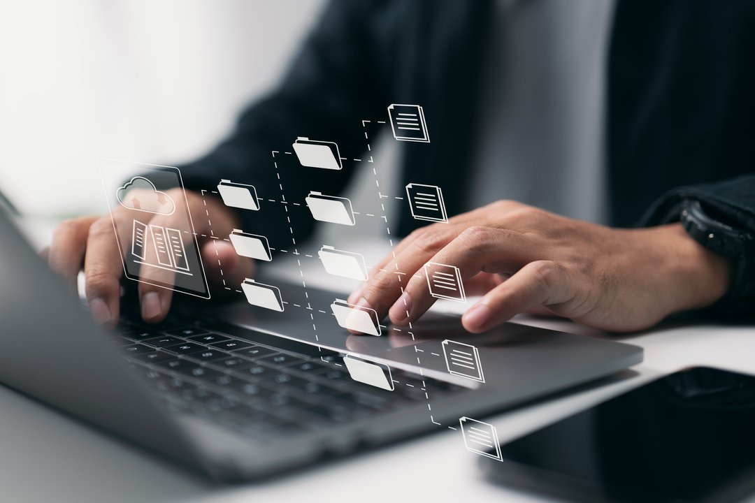 Homem de negócios organizando o GED em seu notebook com facilidade graças à tecnologia.
